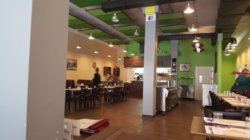 Chanchai dining room with bright green walls and pendant lighting